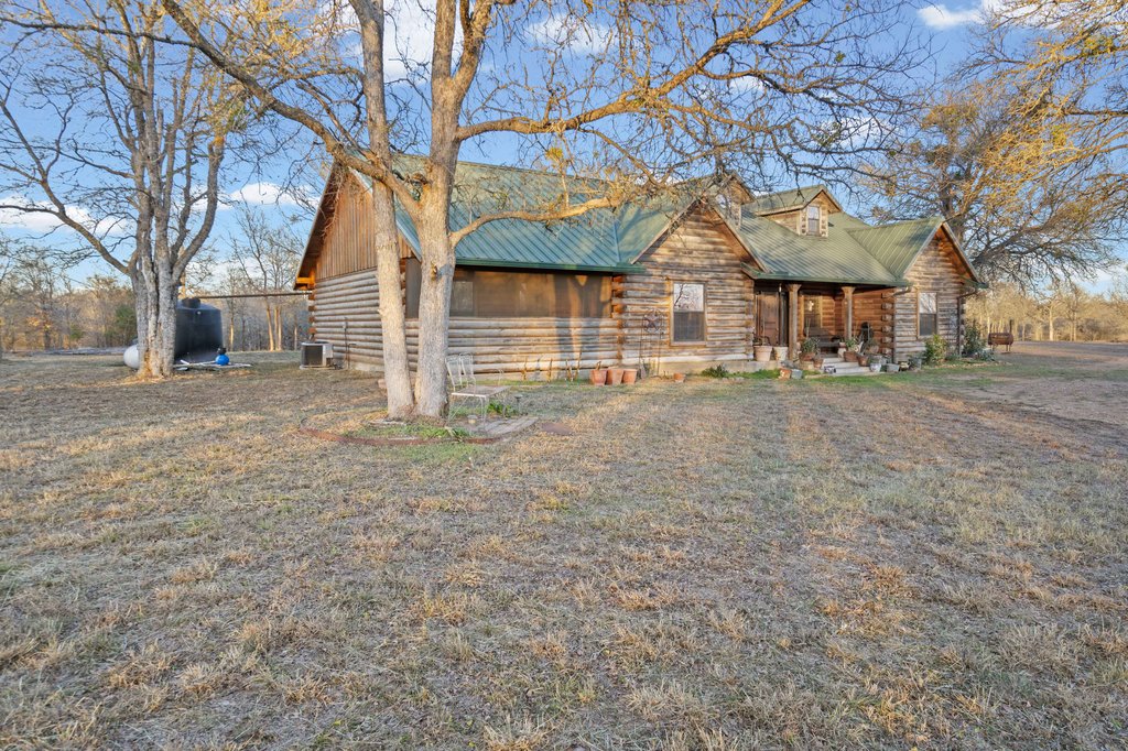 1843 Farm To Market 969 Elgin, TX 78621 - Photo 24 of 28 front view of a house with a tiny house and a trees