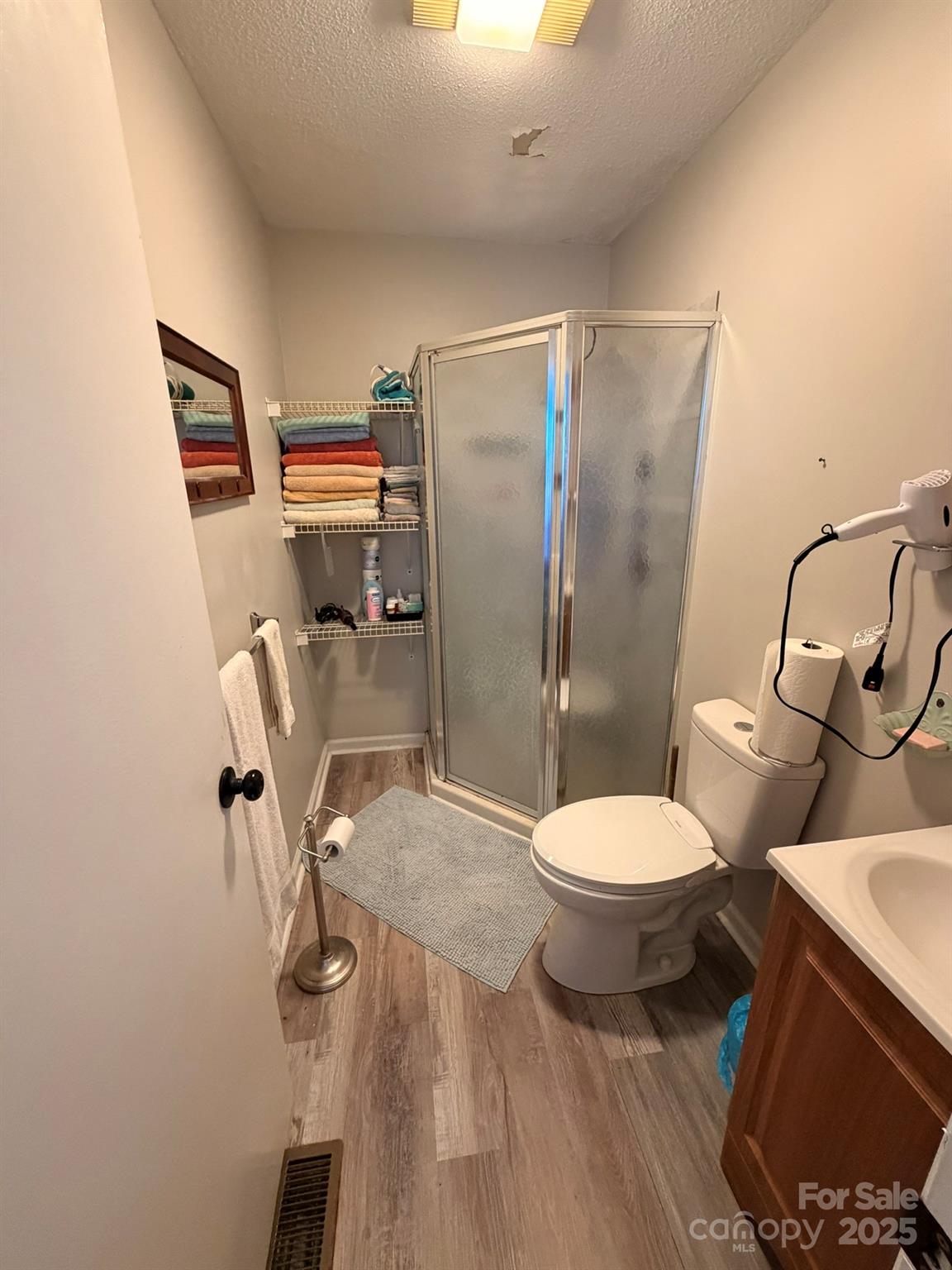 284 Jennings Road North Wilkesboro, NC 28659 - Photo 10 of 11 a white toilet sitting next to a bathroom sink and a shower