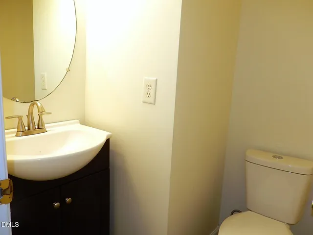 a bathroom with a sink a toilet and mirror