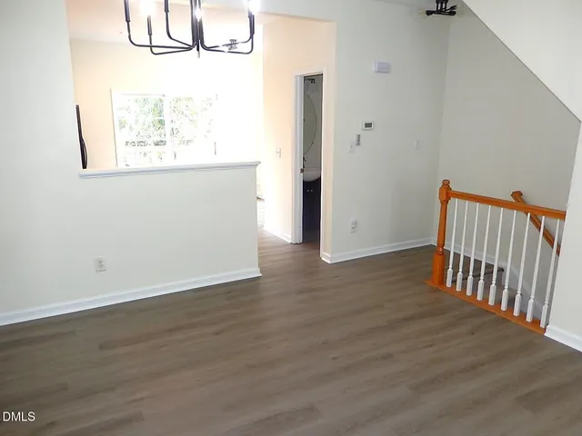 a view of hallway with wooden floor