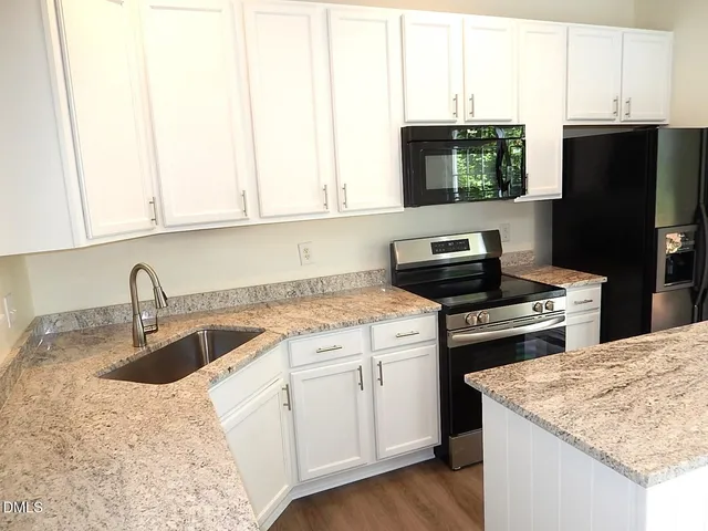 a kitchen with a sink stove and refrigerator