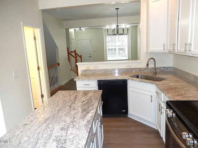 a kitchen with a sink stove and cabinets