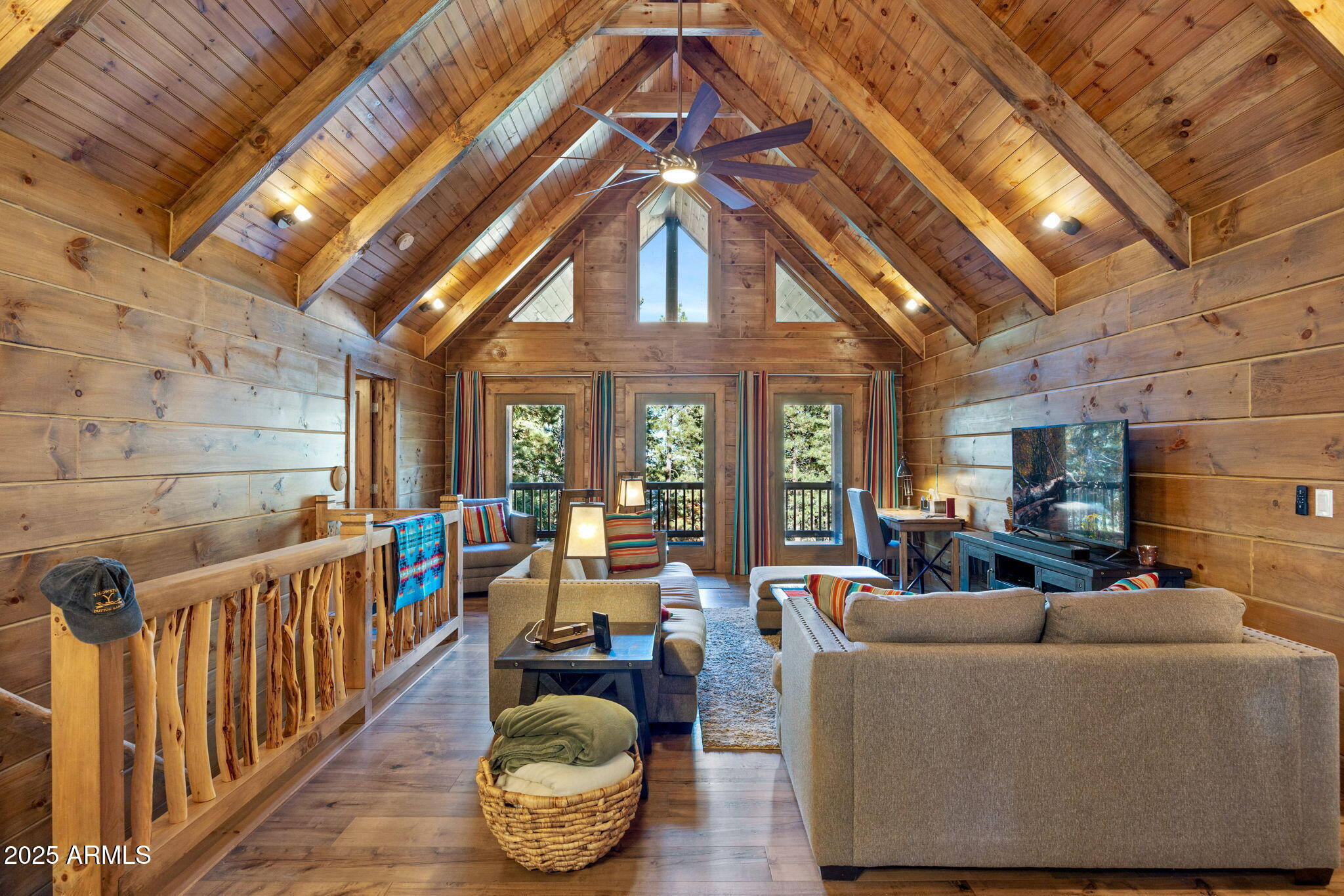 a living room with furniture fireplace and a large window