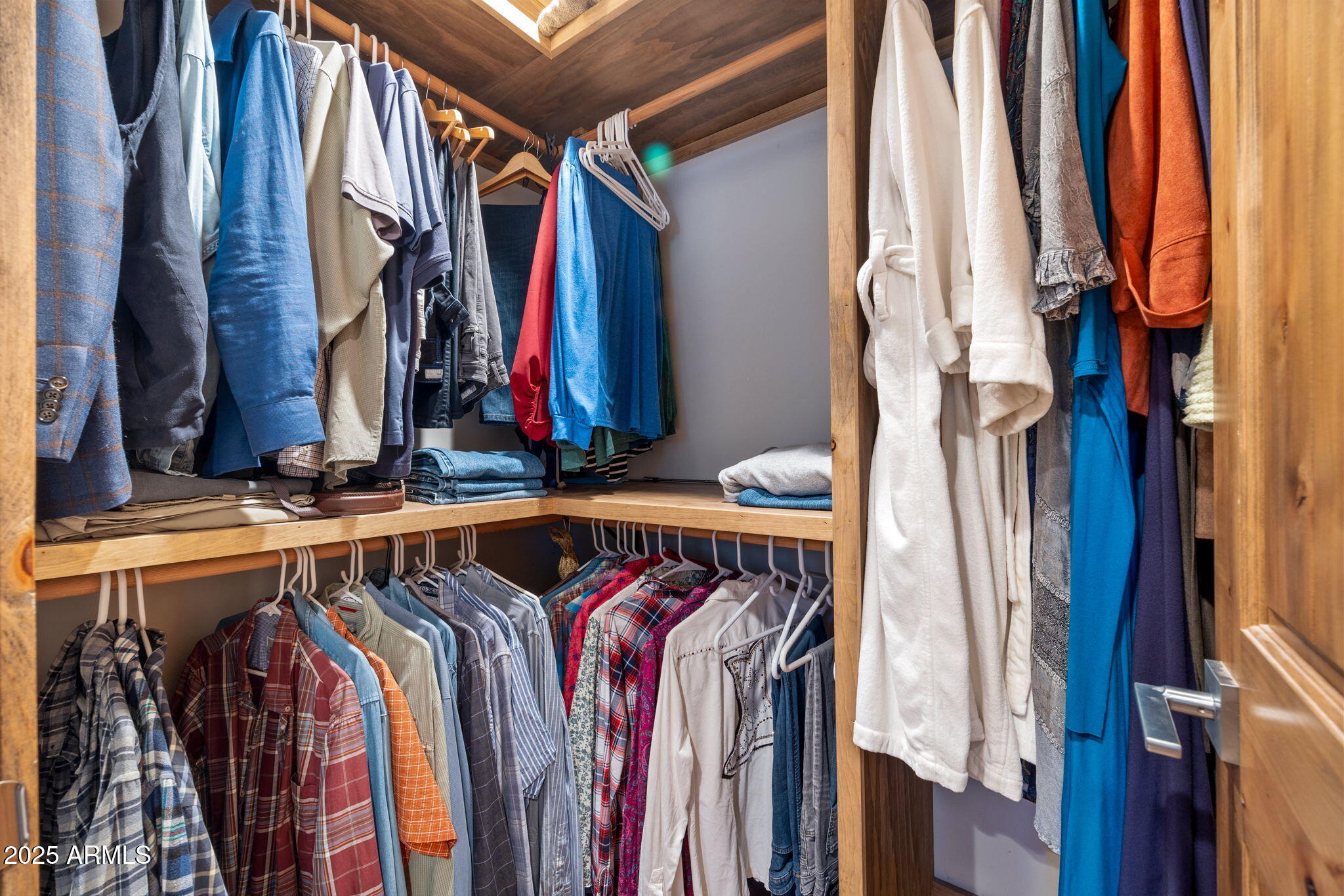 90 North 1330th Road Greer, AZ 85927 - Photo 28 of 44 a view of walk in closet with clothes