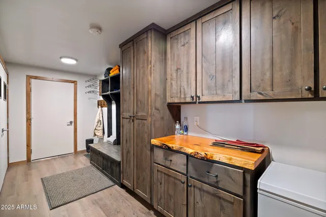 a kitchen with a sink cabinets and wooden floor