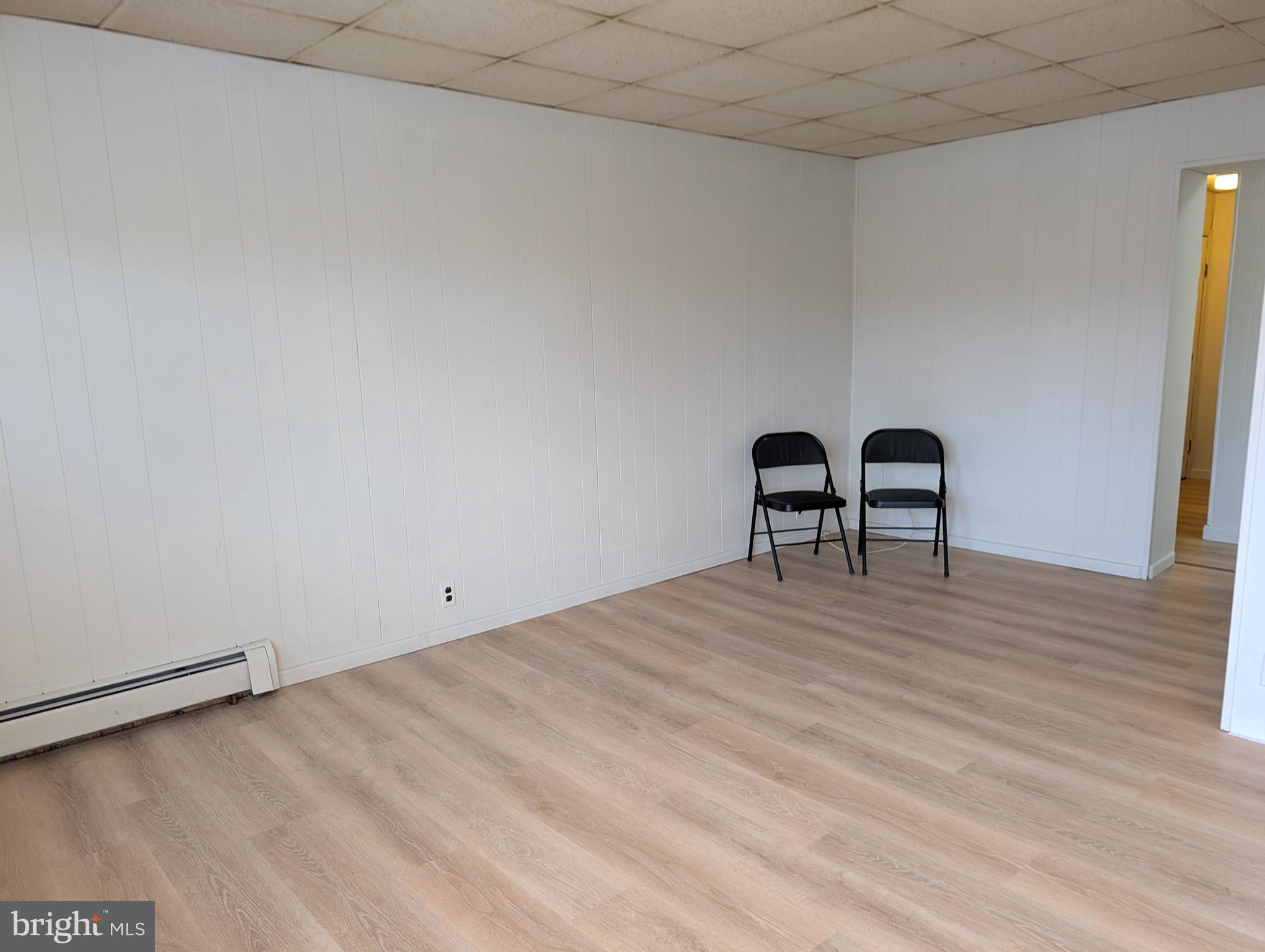 238 Main Street, Unit 3 Hellertown, PA 18055 - Photo 3 of 8 a view of a room with wooden floor and furniture