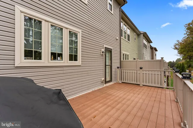 a view of a house with a wooden deck