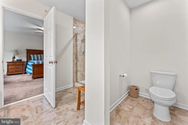 a bathroom with a toilet and a shower