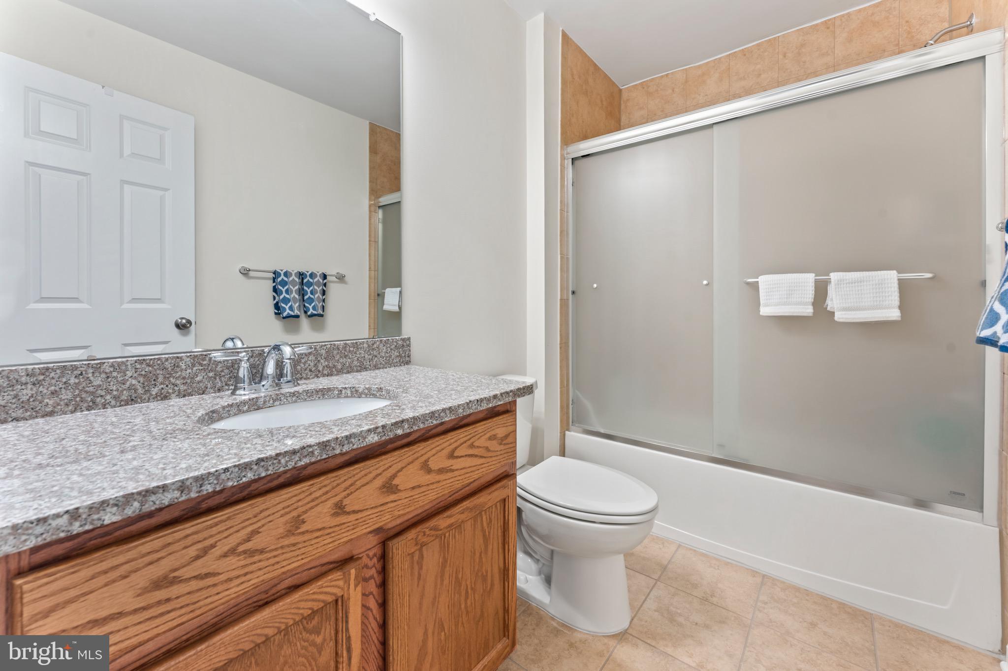 484 Rowan Street Warminster, PA 18974 - Photo 29 of 37 a bathroom with a granite countertop sink toilet and shower