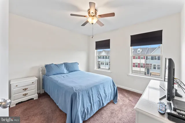 a bedroom with a bed and a flat tv screen on dresser