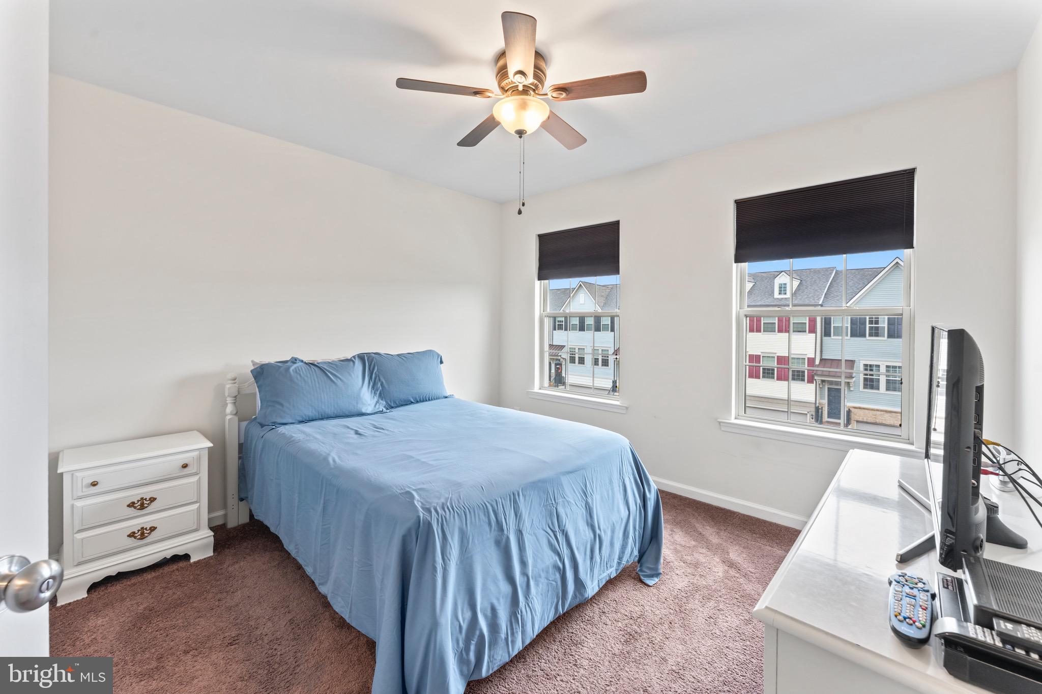 484 Rowan Street Warminster, PA 18974 - Photo 31 of 37 a bedroom with a bed and a flat tv screen on dresser
