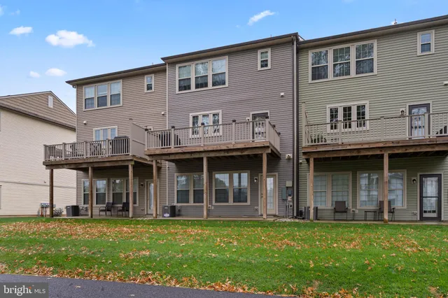 a front view of a building with a garden