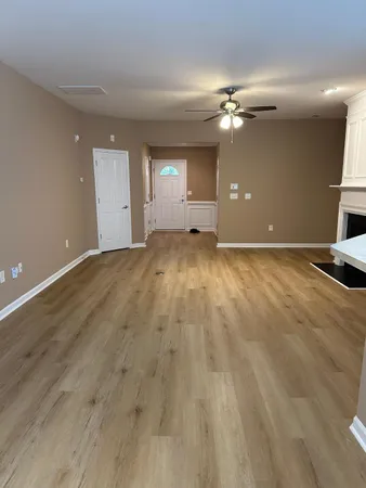 a view of an empty room with window and cabinet