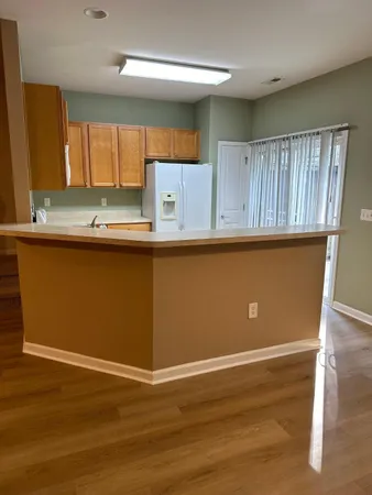 a view of kitchen with wooden floor and window