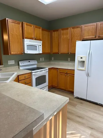 a kitchen with a stove a sink and a refrigerator