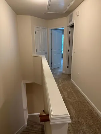 a view of a hallway with staircase