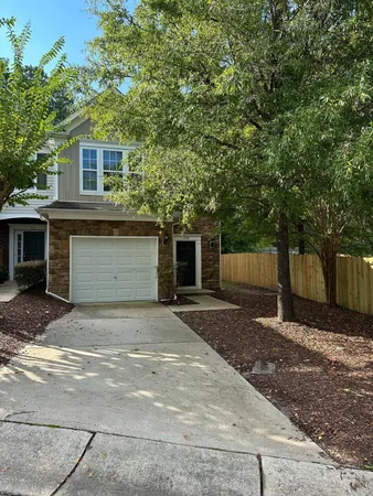a front view of a house with a yard and a garage