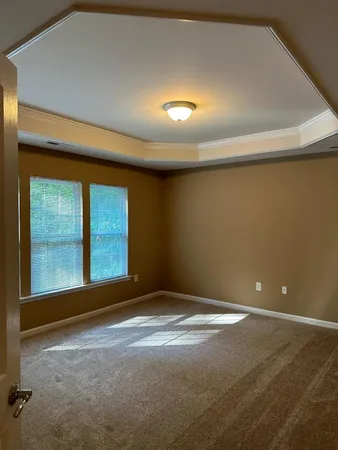 an empty room with a empty space and windows