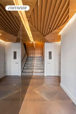 a bathroom with a sink and mirror with bathtub