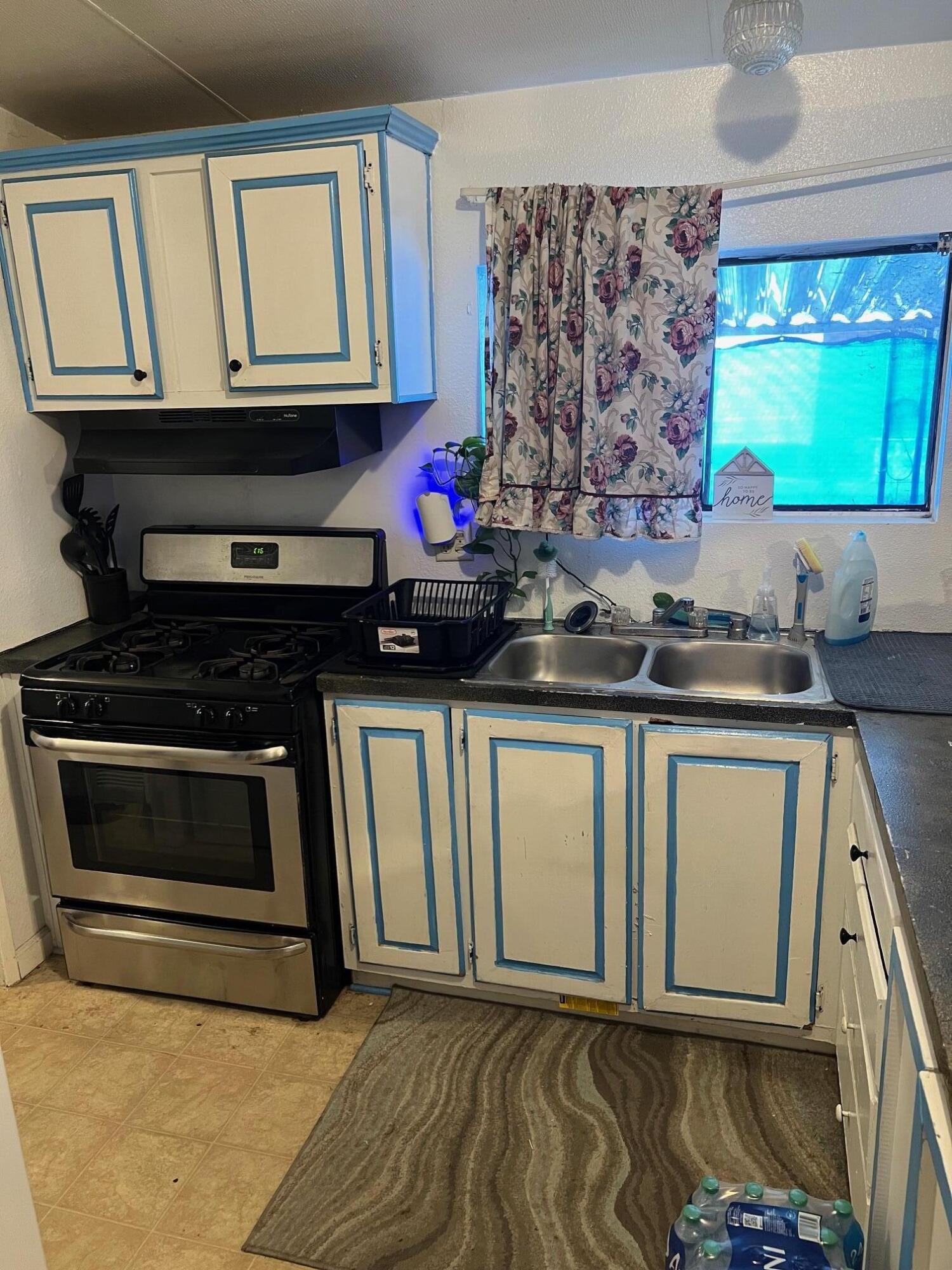 900 East Rankin Road, Unit 5 Tulare, CA 93274 - Photo 6 of 26 a kitchen with stainless steel appliances granite countertop a stove and a microwave
