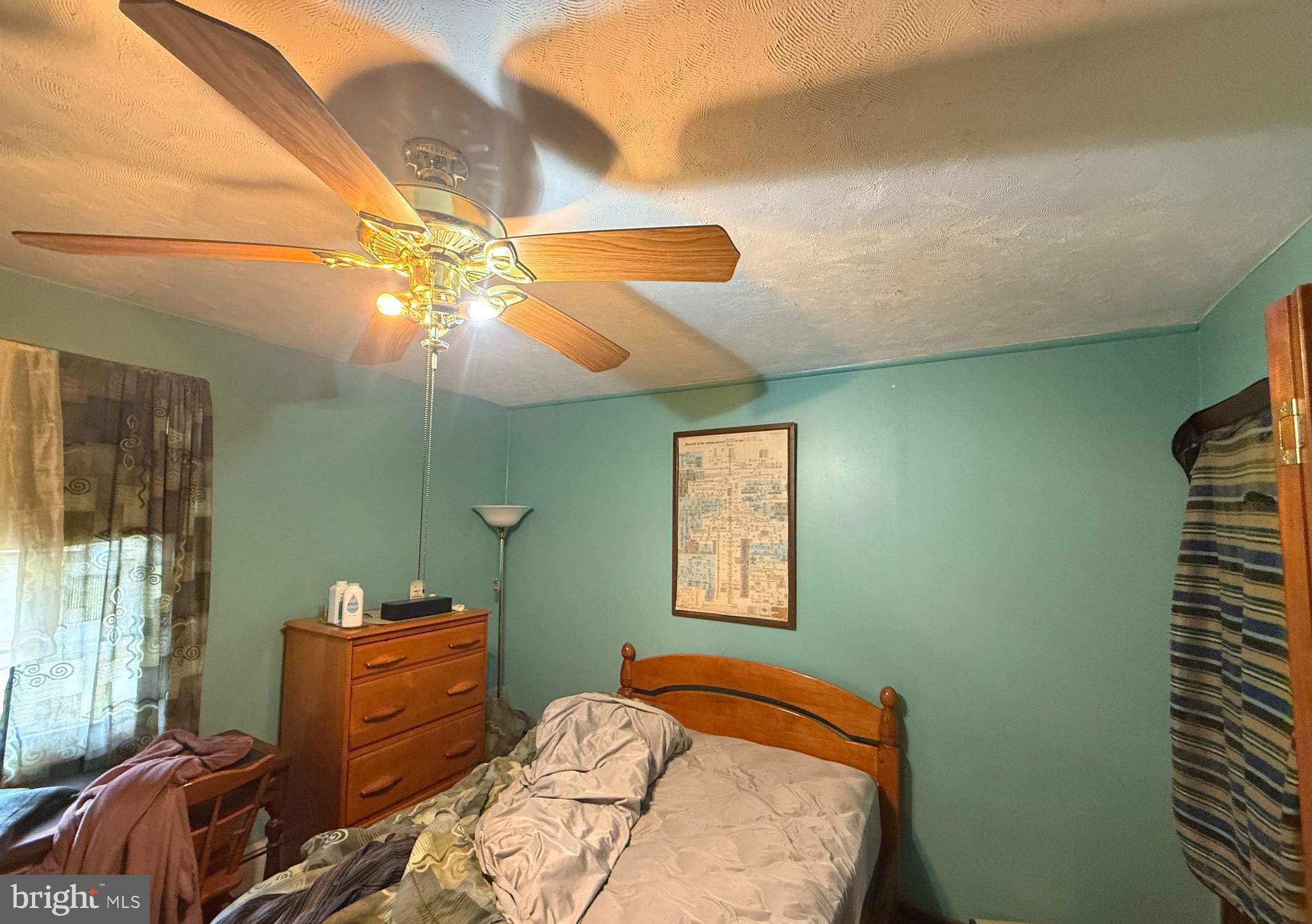 1545 East Buckshutem Road Millville, NJ 08332 - Photo 23 of 41 a bedroom with a bed and a chandelier