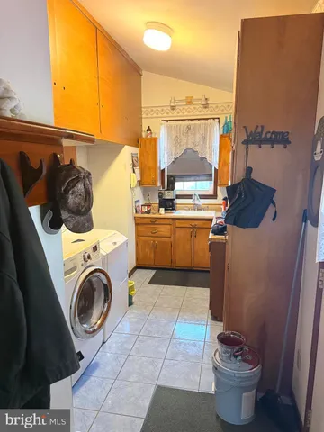 a kitchen with a stove a sink and a washer