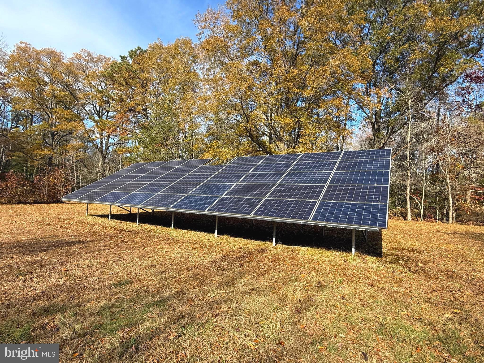 1545 East Buckshutem Road Millville, NJ 08332 - Photo 35 of 41 a backyard of a house with wooden fence and trees