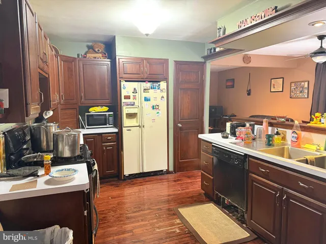 a kitchen with a sink appliances and cabinets