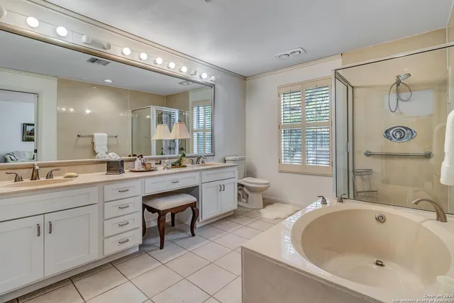 a spacious bathroom with a double vanity sink a large mirror and a bathtub