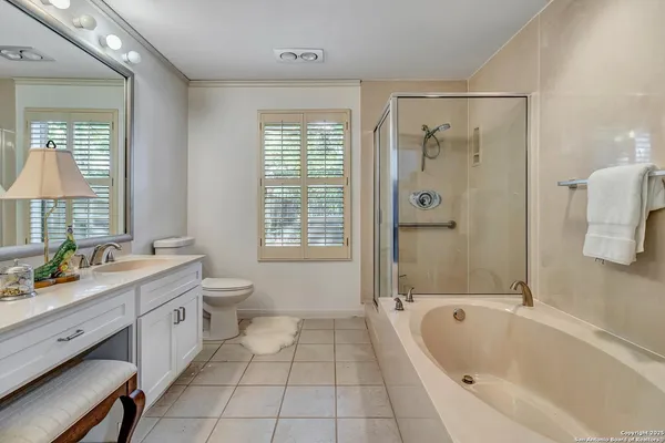 a bathroom with a granite countertop sink a toilet and bathtub