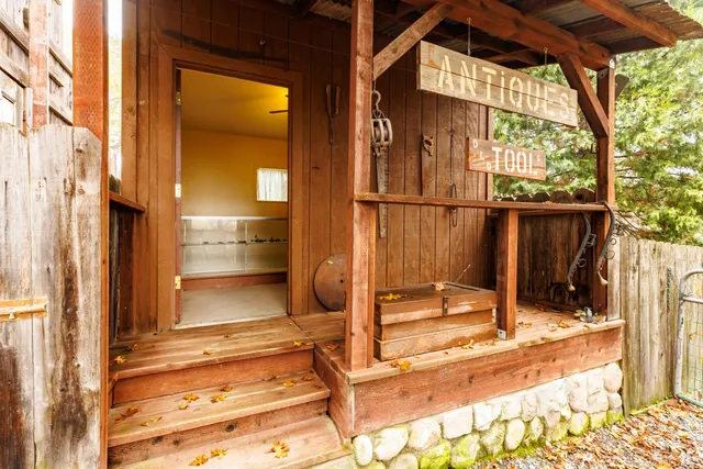 an empty room with white walls and ceiling fan