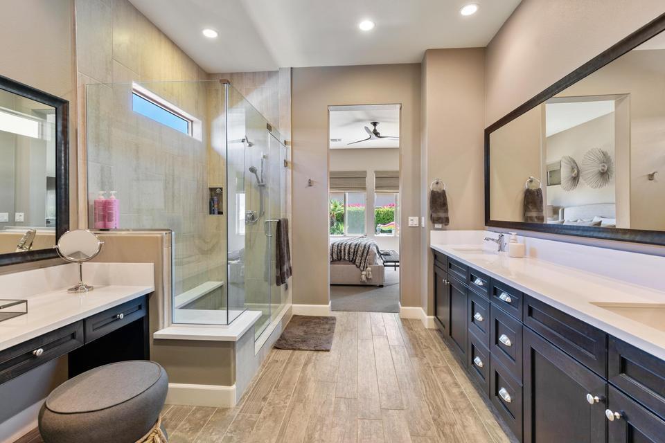 51790 South Two Palms Way Indio, CA 92201 - Photo 15 of 36 a spacious bathroom with a double vanity sink a toilet a mirror and shower