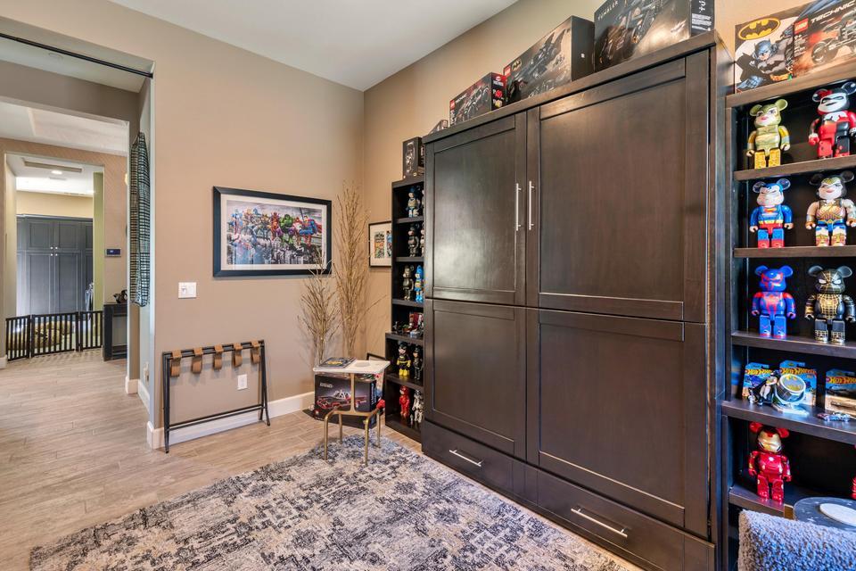 51790 South Two Palms Way Indio, CA 92201 - Photo 21 of 36 a living room with furniture and a book shelf