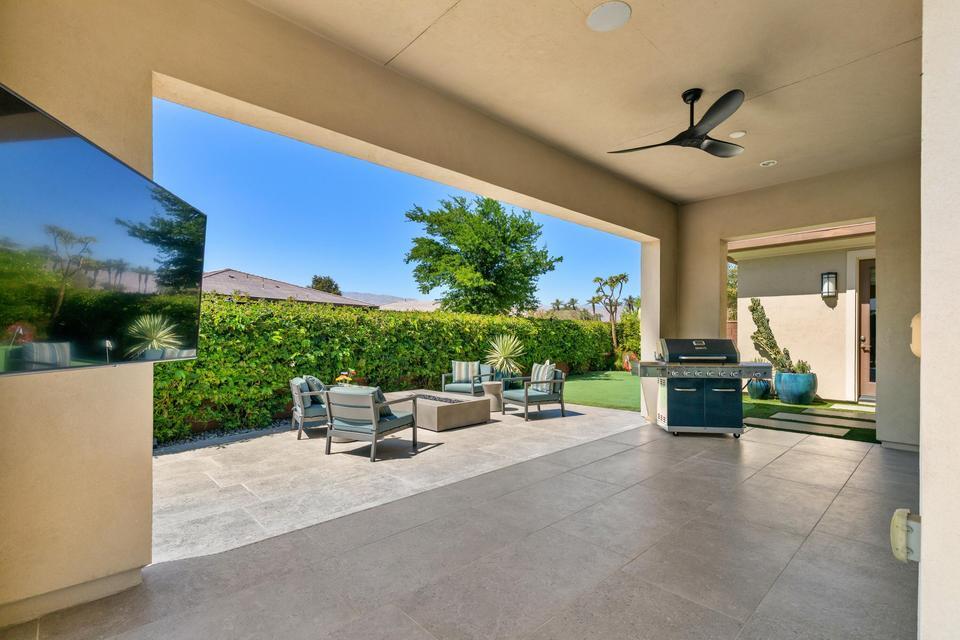 51790 South Two Palms Way Indio, CA 92201 - Photo 25 of 36 a view of a patio with couches table and chairs with potted plants
