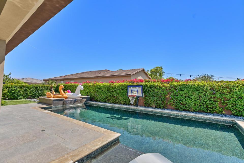 51790 South Two Palms Way Indio, CA 92201 - Photo 27 of 36 a view of a patio with couches and table and chairs under an umbrella