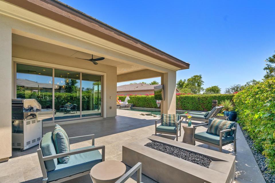 51790 South Two Palms Way Indio, CA 92201 - Photo 31 of 36 a view of a patio with couches chairs and potted plants