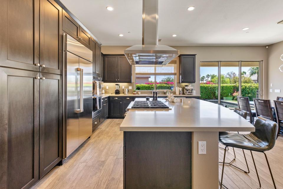 51790 South Two Palms Way Indio, CA 92201 - Photo 8 of 36 a kitchen with kitchen island a large counter top space appliances and windows