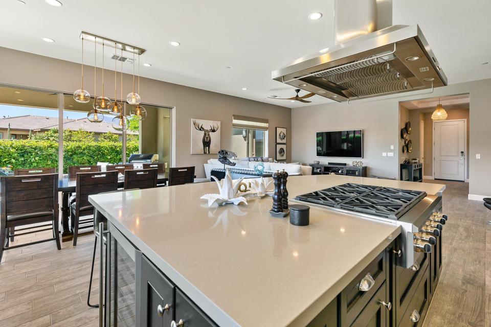 51790 South Two Palms Way Indio, CA 92201 - Photo 9 of 36 a large kitchen with a table and chairs in it