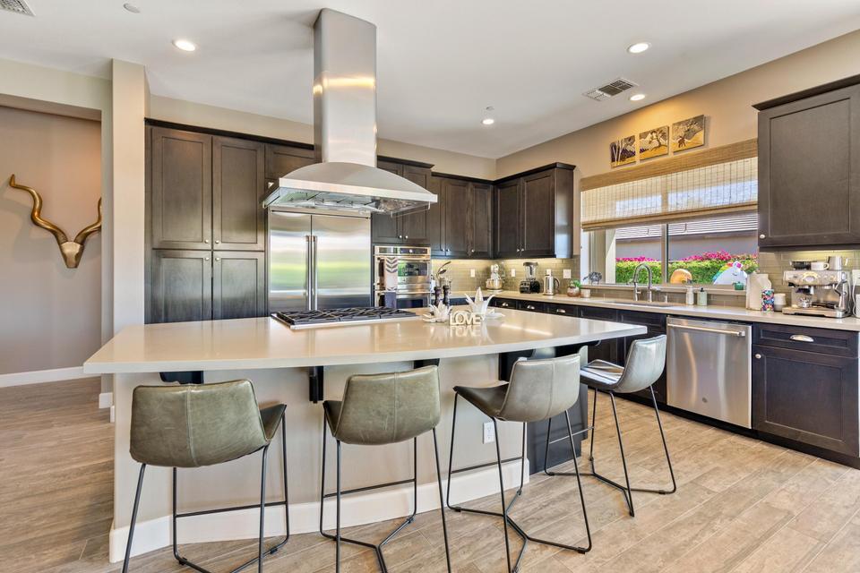 51790 South Two Palms Way Indio, CA 92201 - Photo 10 of 36 a kitchen with a dining table chairs sink and cabinets