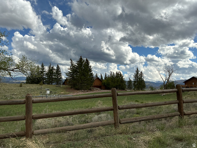 550 State Line Road Manila, UT 84046 - Photo 4 of 41 Rustic split-rail fence enclosing a spacious grassy area with evergreen trees