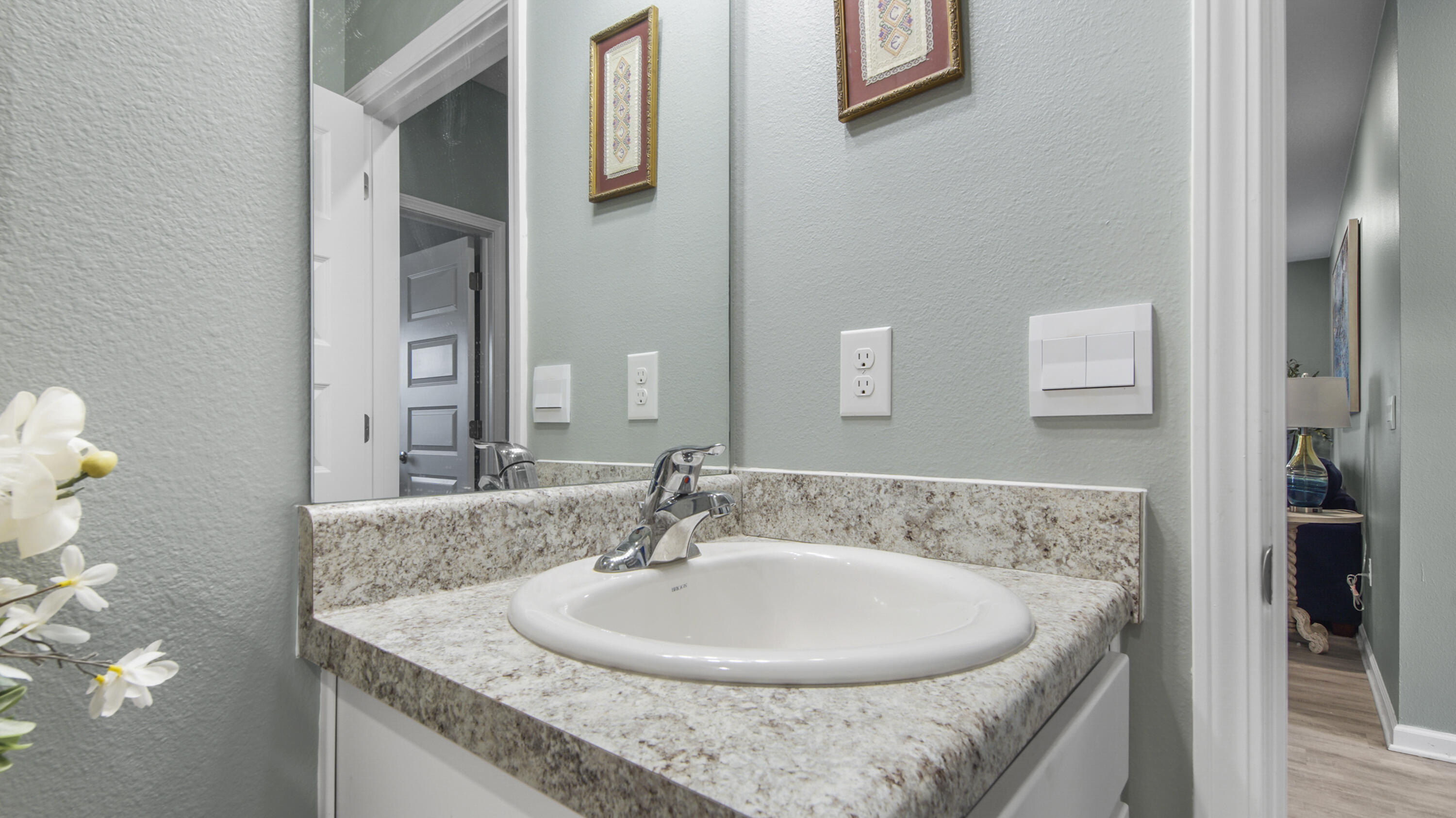 41 Woodsorrel Street Freeport, FL 32439 - Photo 16 of 41 a bathroom with a granite countertop sink and a mirror