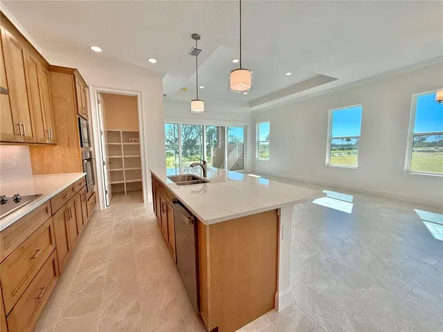 a kitchen with a table chairs sink and cabinets