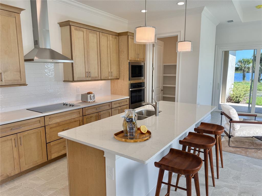4 Coronado Road Flagler Beach, FL 32136 - Photo 14 of 63 a kitchen with a table chairs sink and cabinets