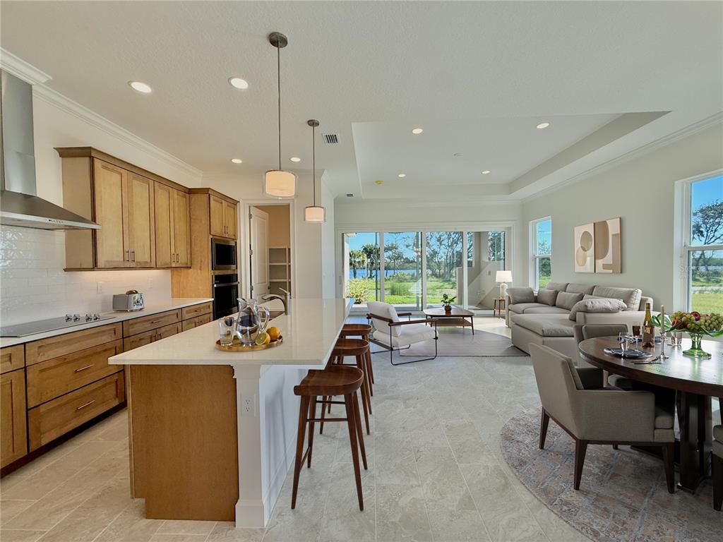 4 Coronado Road Flagler Beach, FL 32136 - Photo 16 of 63 a view of a dining room and livingroom with furniture a rug a kitchen and a chandelier