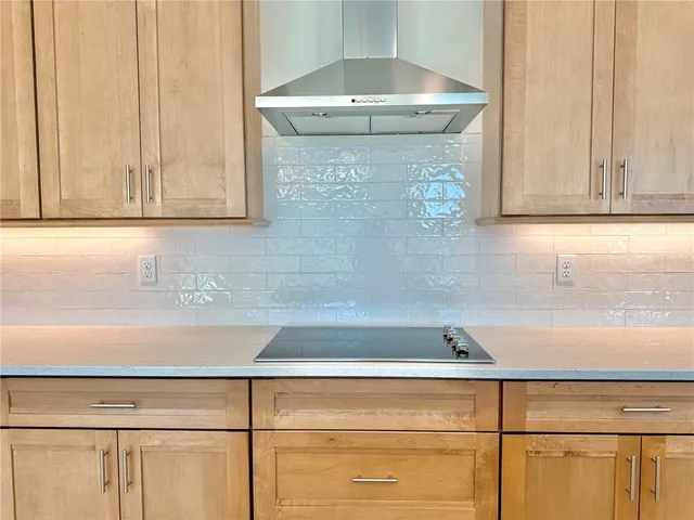 a kitchen with stainless steel appliances granite countertop a sink a stove and a refrigerator