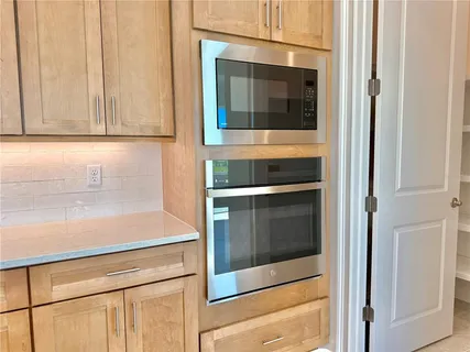 a kitchen with kitchen island a sink stove and refrigerator