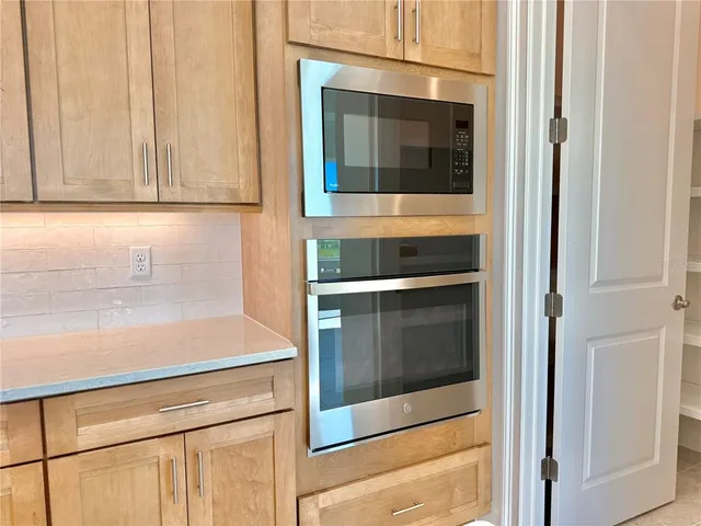 a kitchen with kitchen island a sink stove and refrigerator