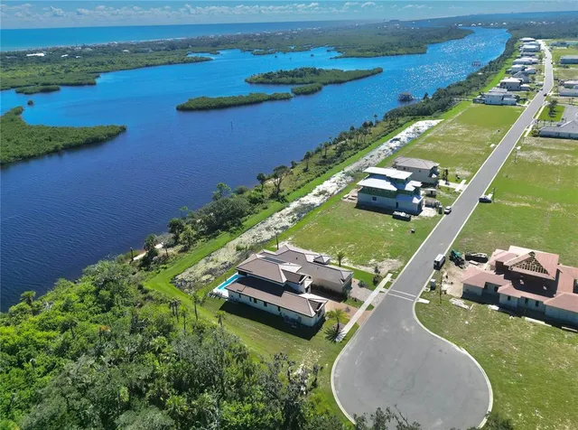 an aerial view of a house with a yard
