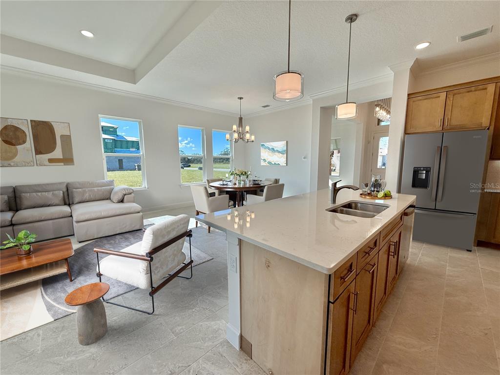 4 Coronado Road Flagler Beach, FL 32136 - Photo 25 of 63 a kitchen with a sink a counter and chairs in it
