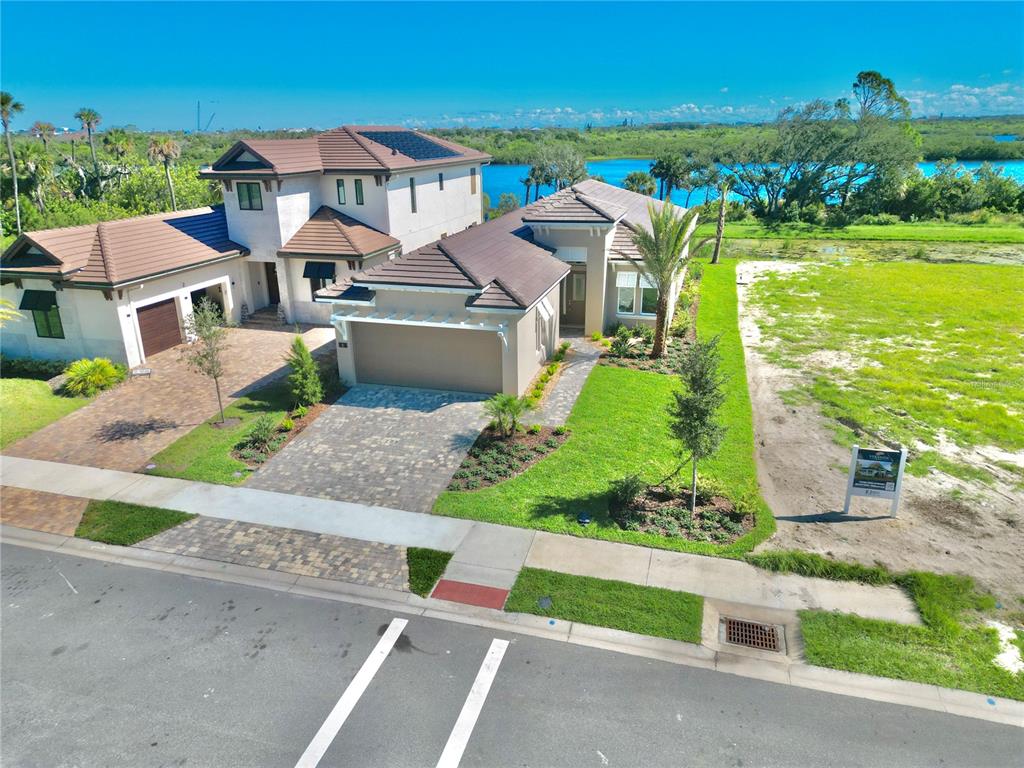 4 Coronado Road Flagler Beach, FL 32136 - Photo 3 of 63 an aerial view of a house with a garden and lake view